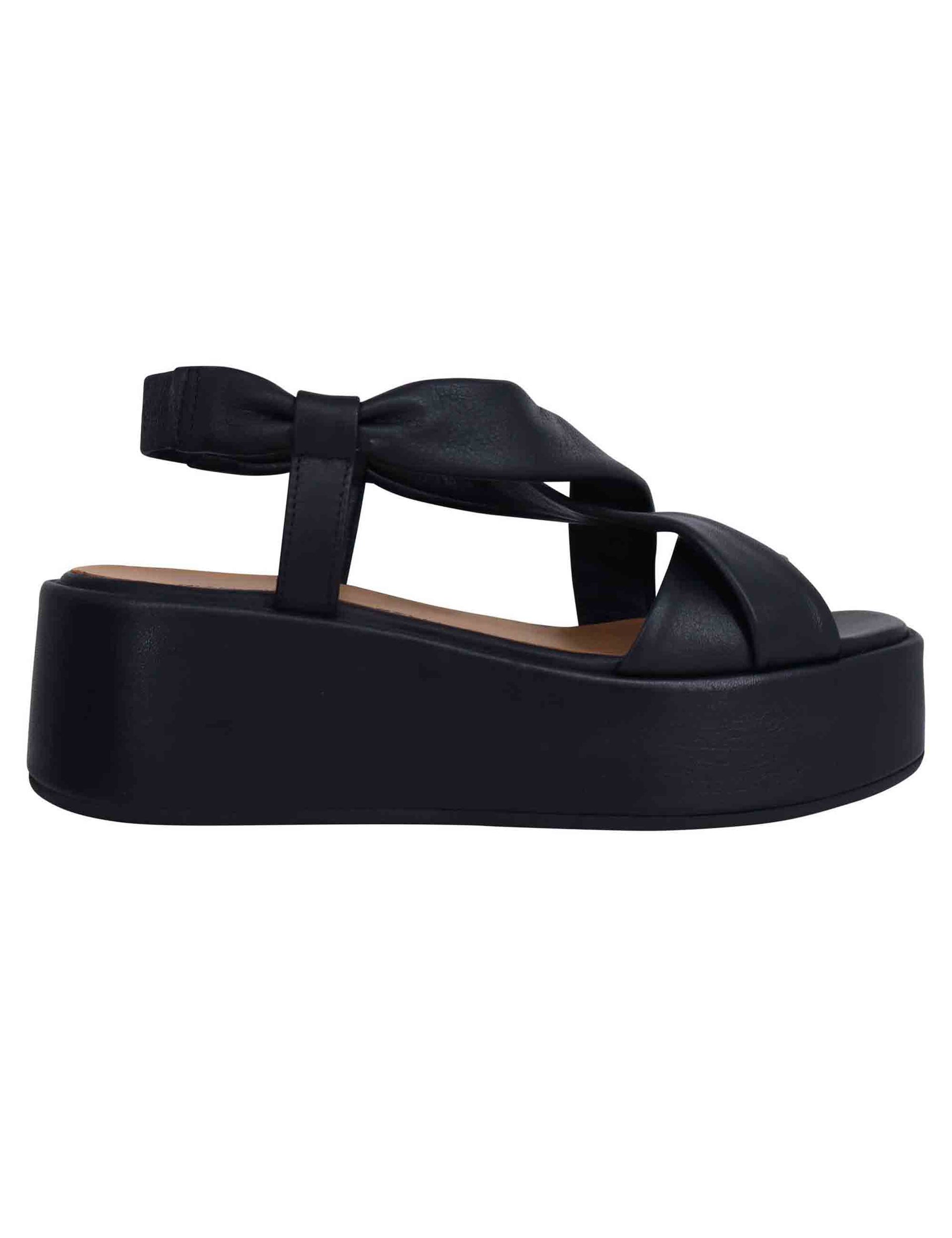Women's black leather sandals with matching banded wedge