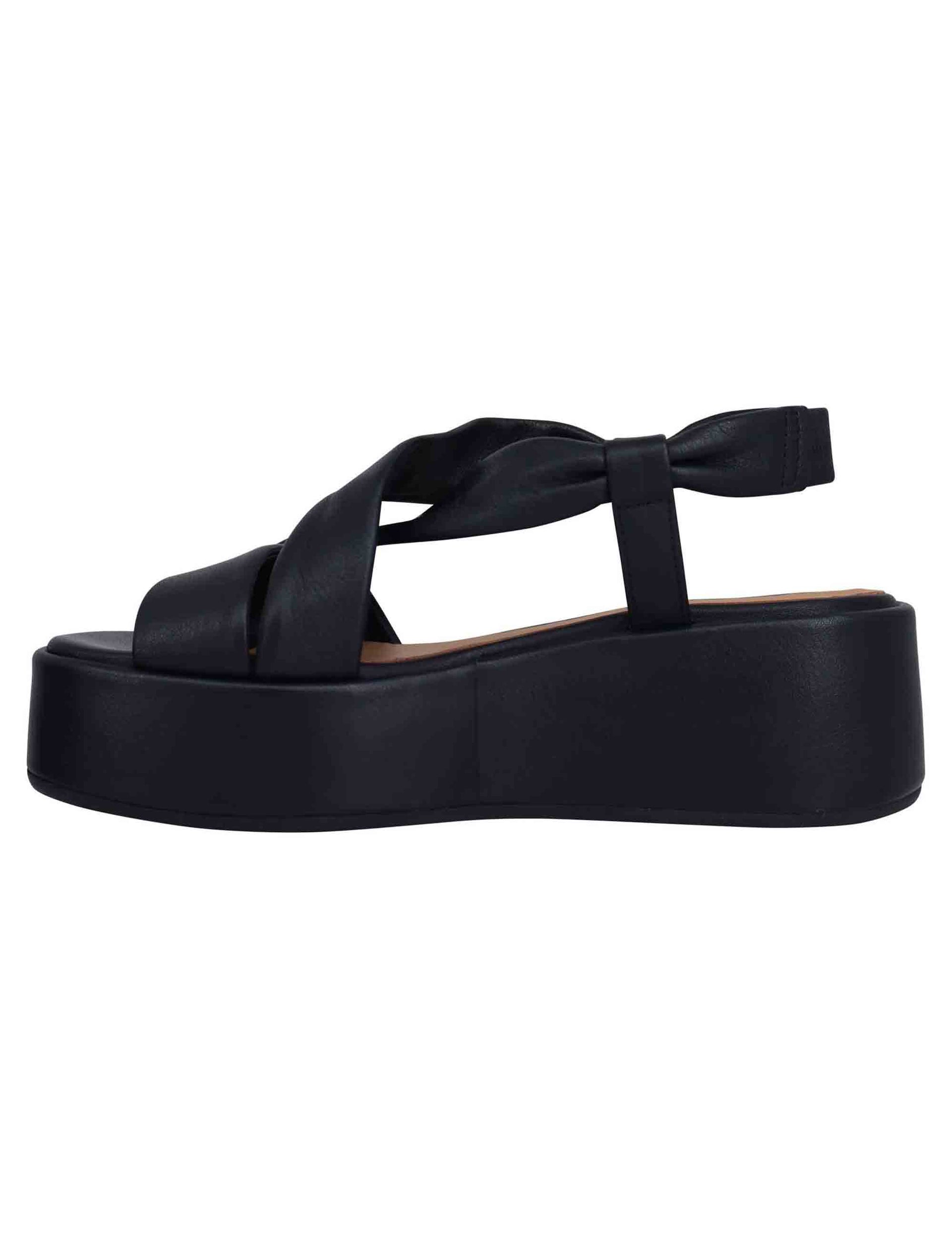 Women's black leather sandals with matching banded wedge