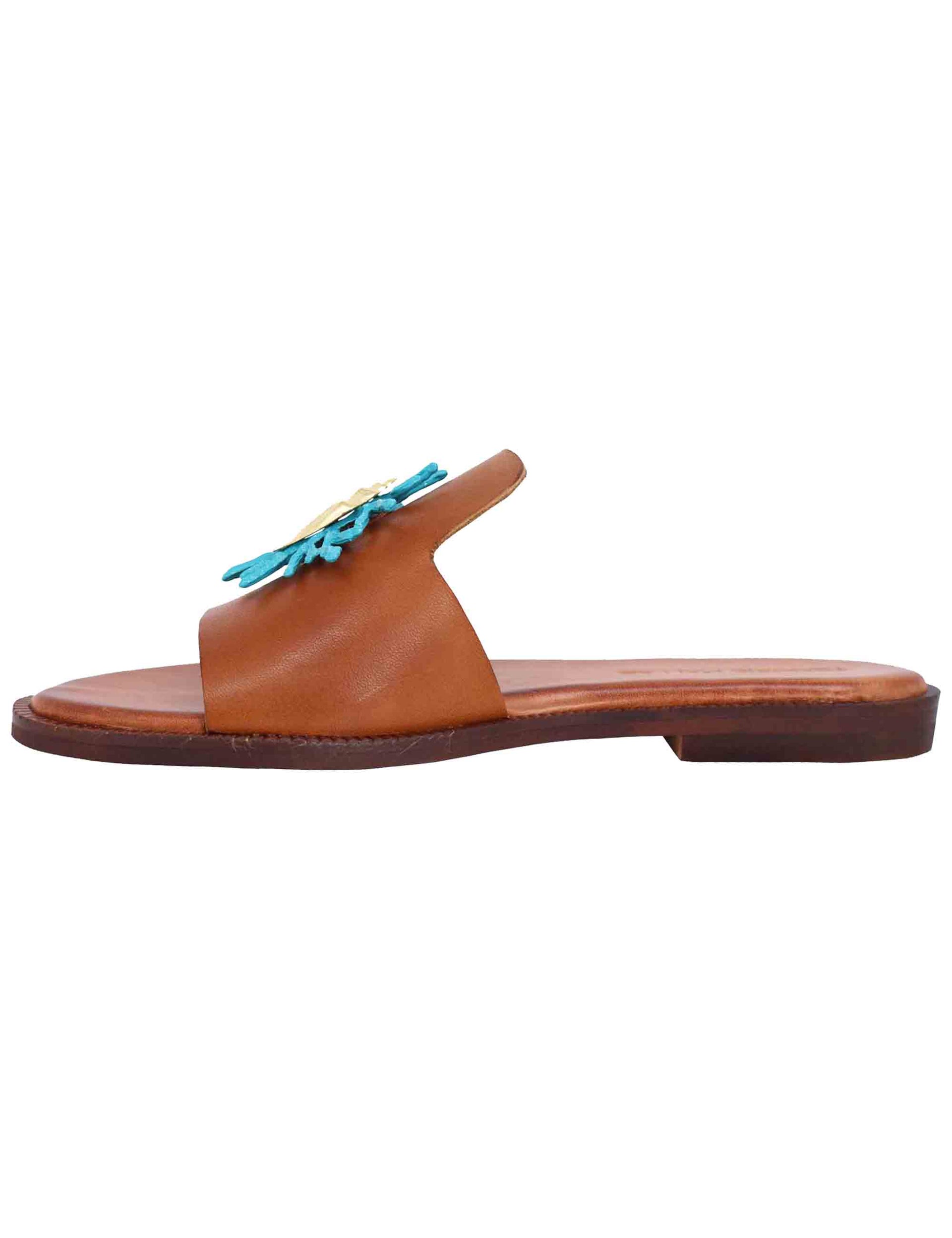 Women's flat sandals in tan leather with turquoise accessory